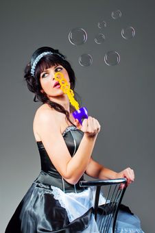 Portrait Of Young Woman Inflating Soap-bubbles Royalty Free Stock Image Portrait Of Young Woman Inflating Soap-bubbles Royalty Free Stock Image