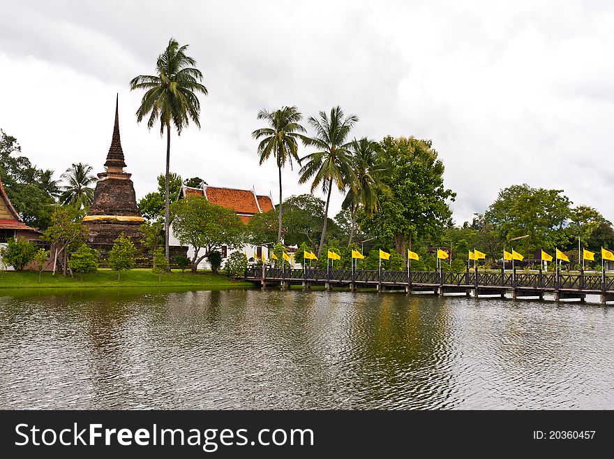 Wooden bridge to ruin pagoda cross river in Sukhothai