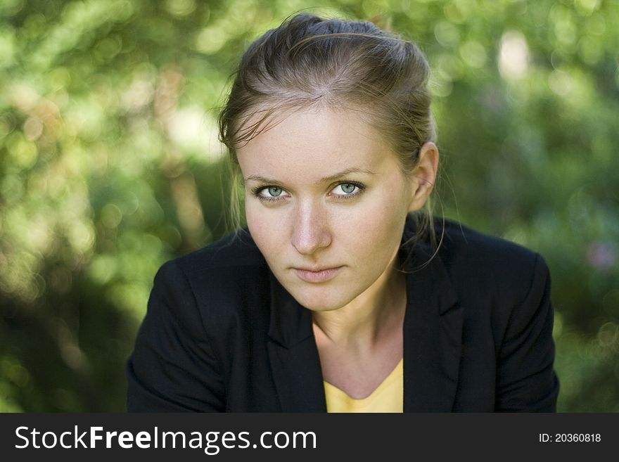 Pretty girl relaxing outdoor, on green floral background