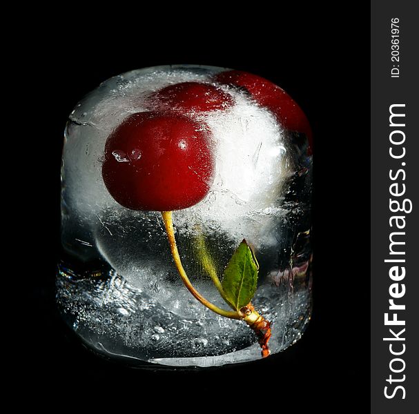 Cherry in ice on a black background