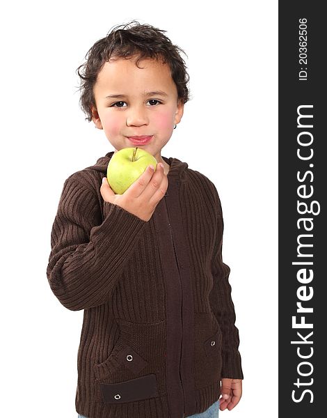 Little boy holding a golden apple while chewing. Little boy holding a golden apple while chewing