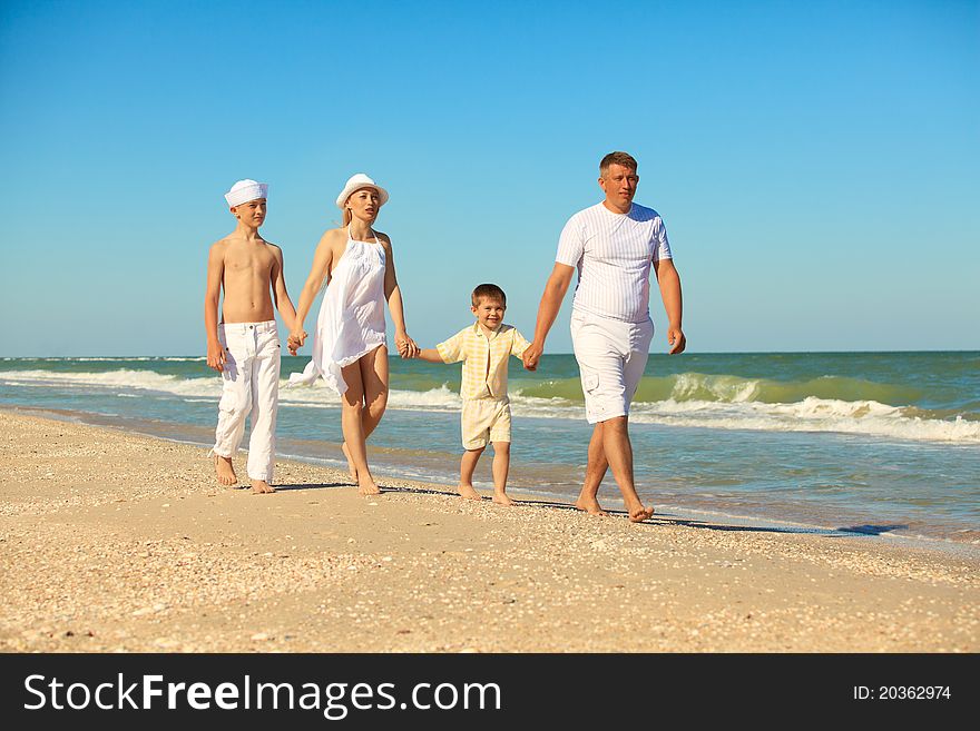 Family walking along the beach while on vacation