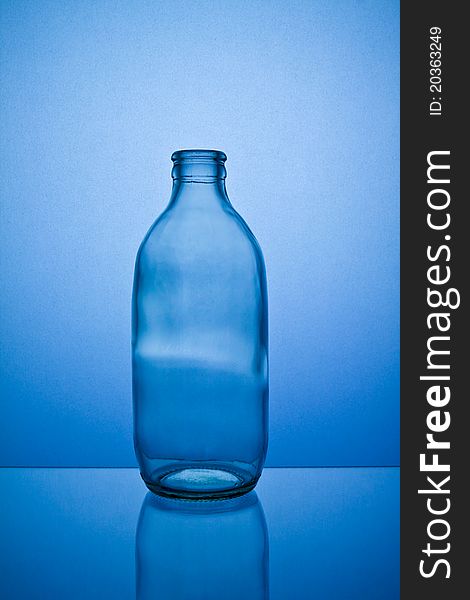 Empty bottle isolated on blue background