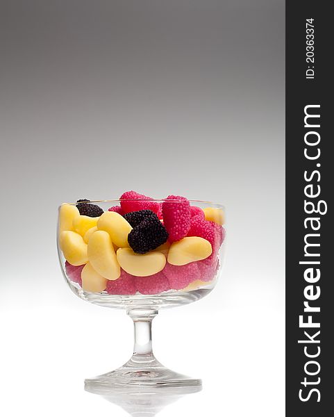 Jelly beans in a glass on gradient background