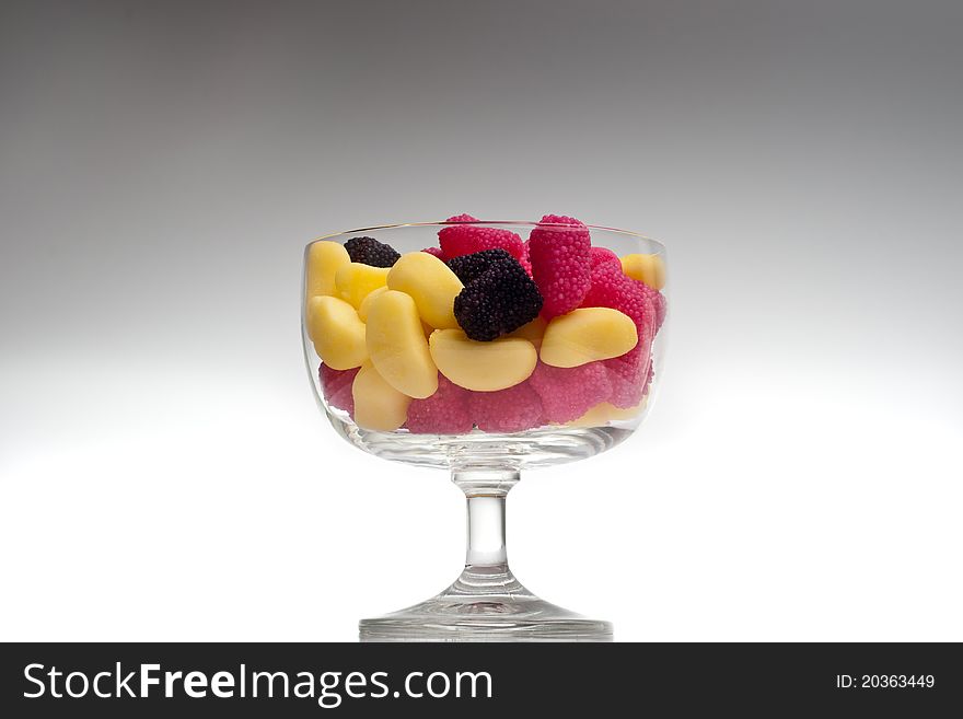 Jelly beans in a glass on gradient background