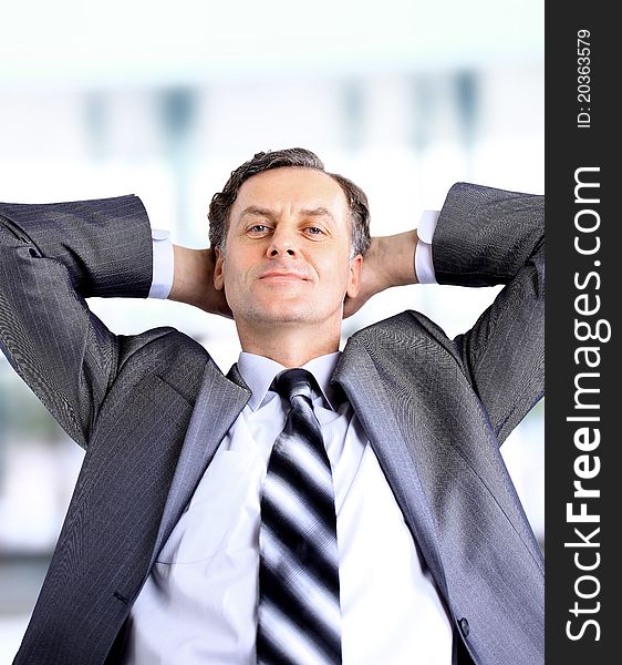 Relaxed and dreaming business man sits on office chair. Relaxed and dreaming business man sits on office chair