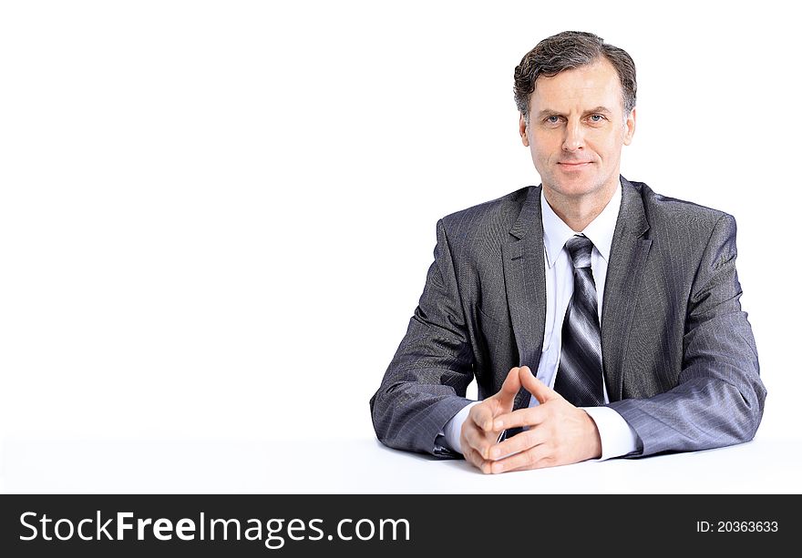 Young business man on a desk, isolated on white. Young business man on a desk, isolated on white