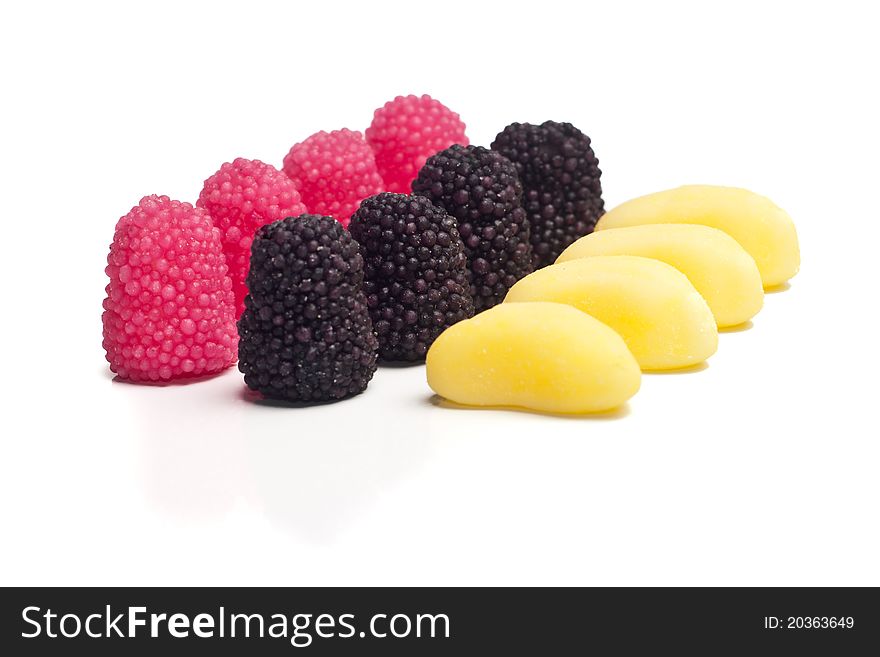 Blackberry jelly beans in formation, on a white background