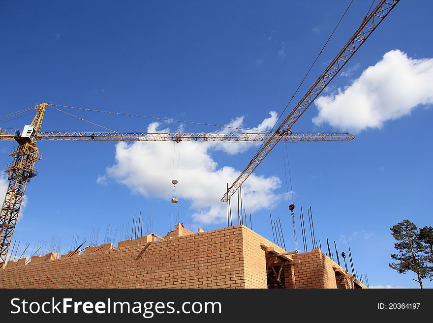 Working cranes on building a new house. Working cranes on building a new house.