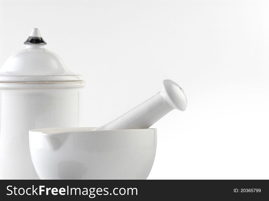 White ceramic mortar and pestle on white background.