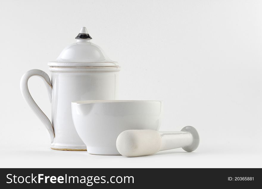 White ceramic mortar and pestle on white background.