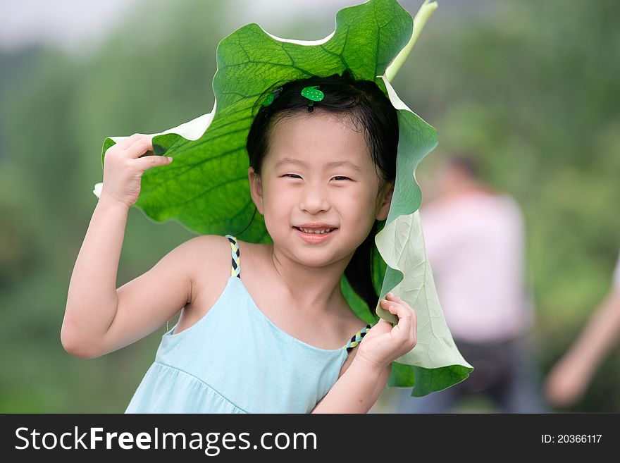 Chinese girl with lotus leaf hat