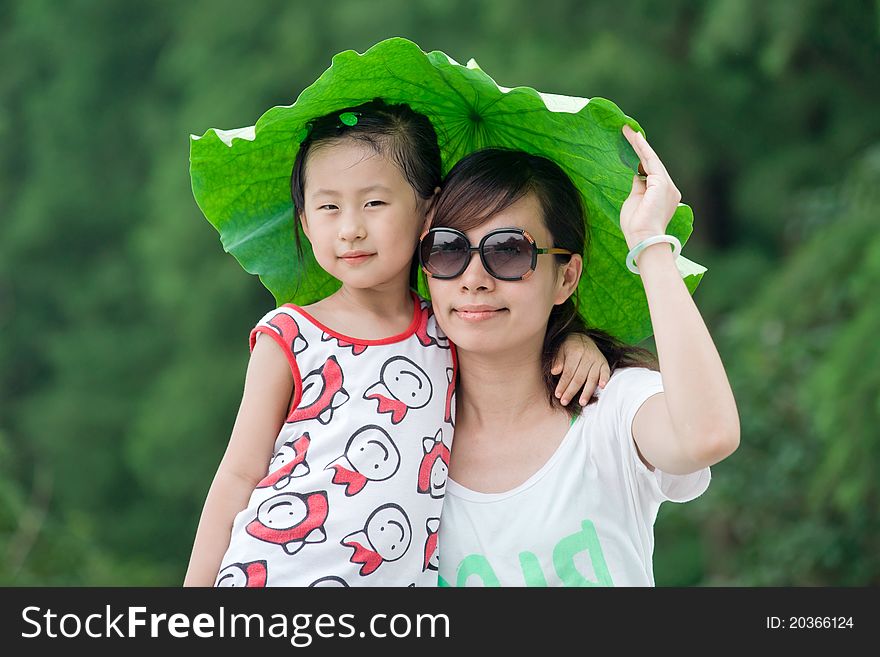 Chinese Girl And Mum With Lotus Leaf Hat