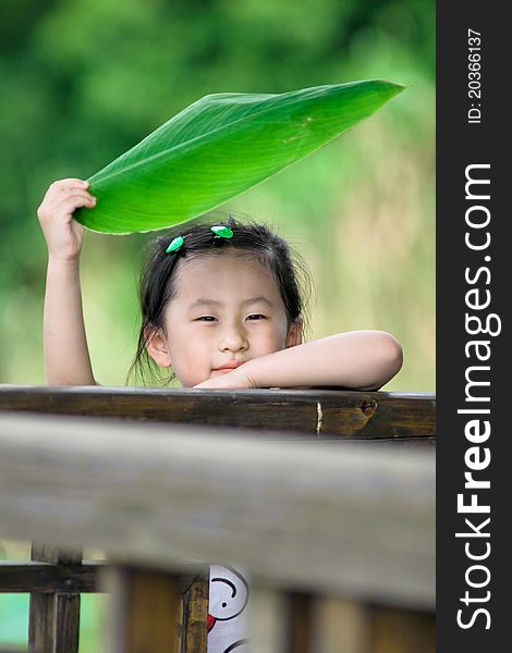 Chinese girl with lotus leaf hat