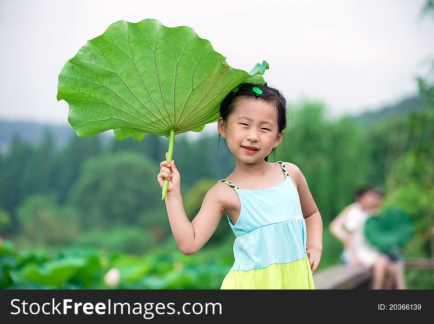 Chinese girl with lotus leaf hat
