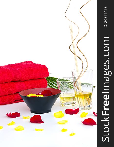 SPA Background of red towels and red rose with Massage Oil Glasses