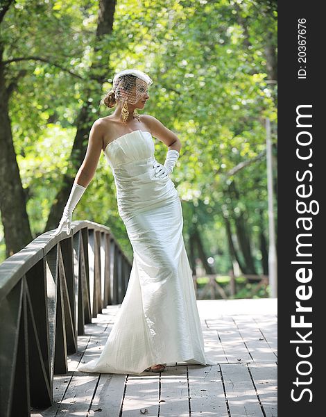 Beautiful bride woman people in fashion wedding dress posing outdoor in bright park. Beautiful bride woman people in fashion wedding dress posing outdoor in bright park