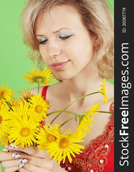Blonde with the yellow flowers on green background. Blonde with the yellow flowers on green background