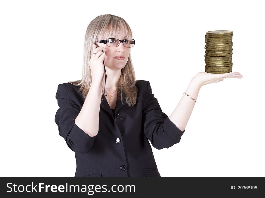 Pretty woman talking on the phone holding gold coins. Pretty woman talking on the phone holding gold coins