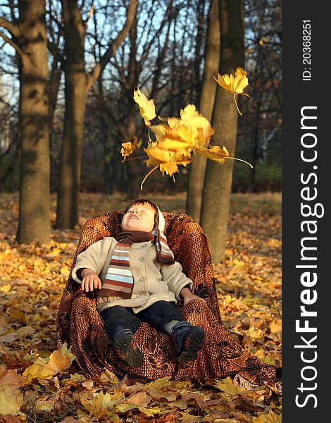 Portrait of a little boy sitting outside in a kiddie chair. Portrait of a little boy sitting outside in a kiddie chair