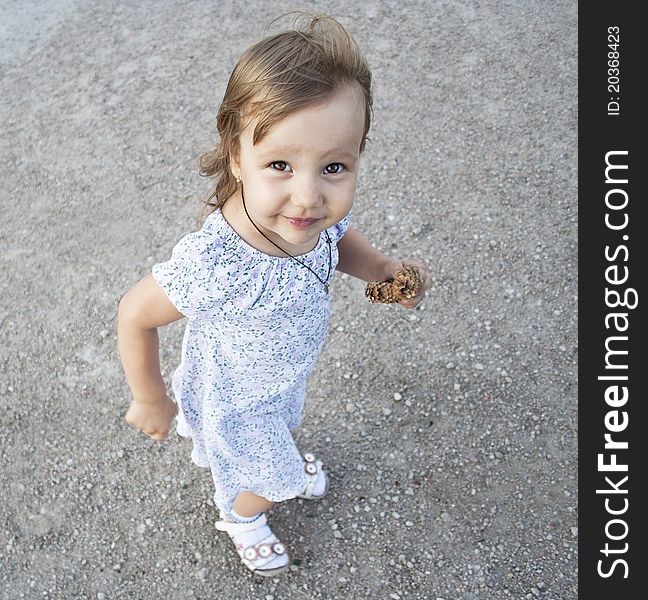 Portrait of blonde little girl outdoors in summer