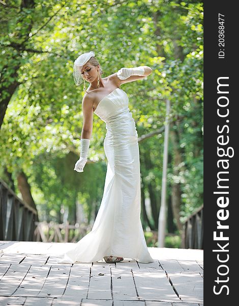 Beautiful bride woman people in fashion wedding dress posing outdoor in bright park. Beautiful bride woman people in fashion wedding dress posing outdoor in bright park