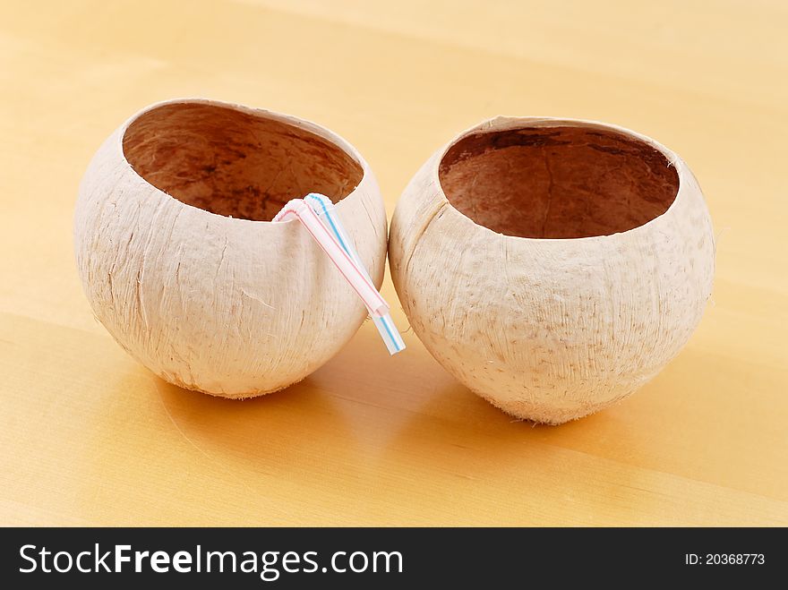 Coconut Cups With Straws On Wood