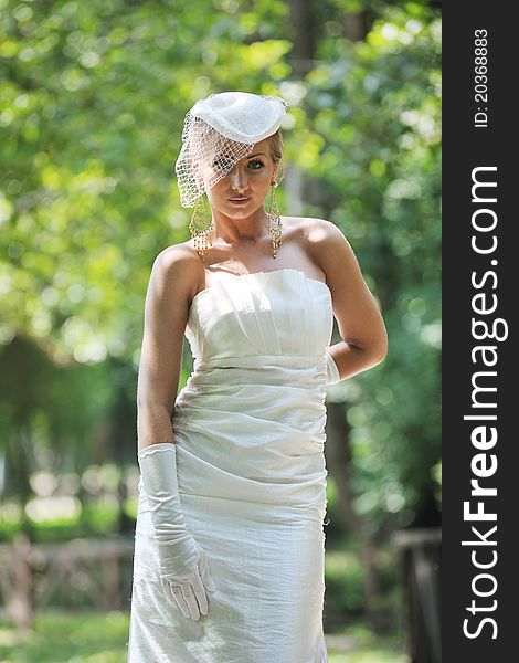 Beautiful bride woman people in fashion wedding dress posing outdoor in bright park. Beautiful bride woman people in fashion wedding dress posing outdoor in bright park