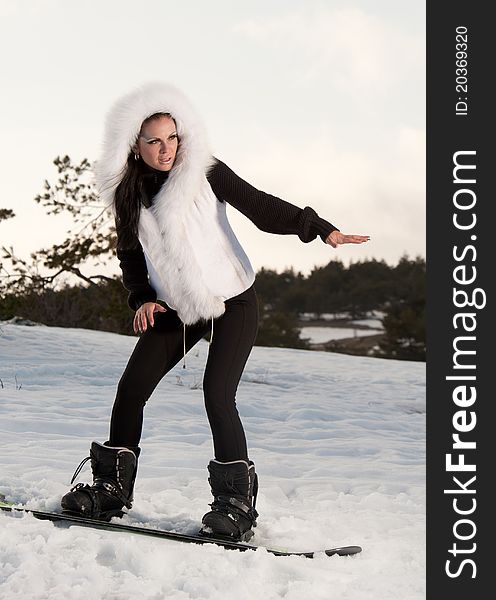 Girl with a snowboard on the mountain is. Girl with a snowboard on the mountain is