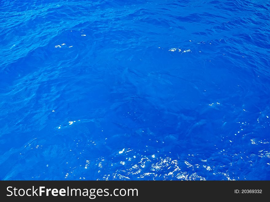 Blue Caribbean Sea Background with Sun Reflections