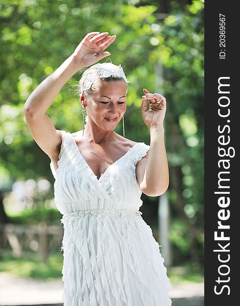 Beautiful bride woman people in fashion wedding dress posing outdoor in bright park. Beautiful bride woman people in fashion wedding dress posing outdoor in bright park