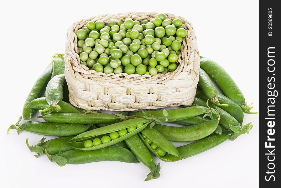 Wood basket with green peas the isolated. Wood basket with green peas the isolated