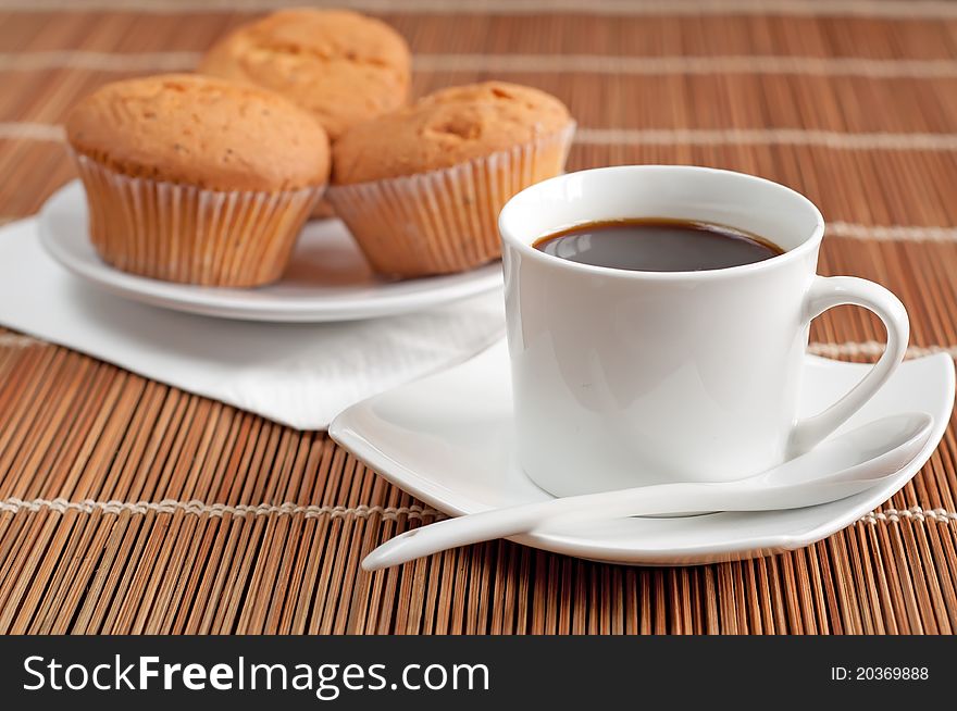 On a photo the cup of coffee is presented with the dessert. On a photo the cup of coffee is presented with the dessert