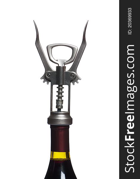 Corkscrew over the wine bottle isolated on white