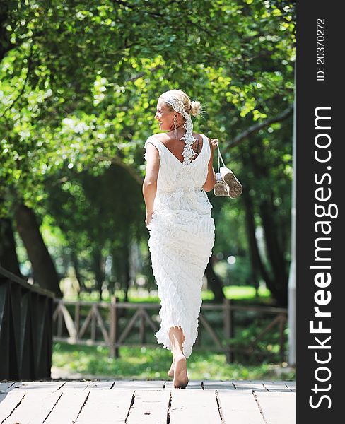 Beautiful bride woman people in fashion wedding dress posing outdoor in bright park. Beautiful bride woman people in fashion wedding dress posing outdoor in bright park