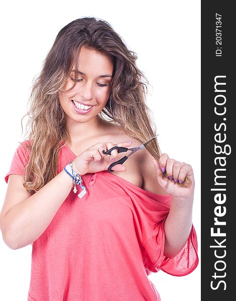 Beautiful woman cutting her hair tips with scissors