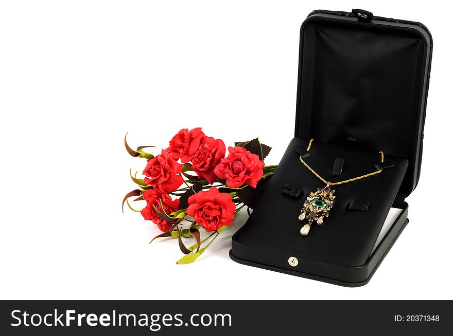 Precious gold necklace in open gift box with flowers. Precious gold necklace in open gift box with flowers