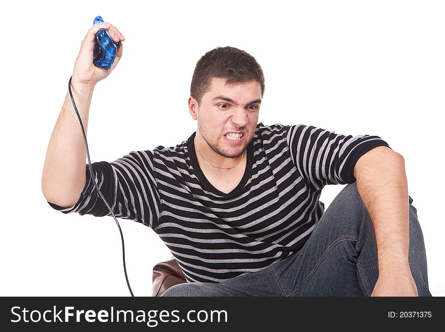 Young and furious man with a joystick for game console