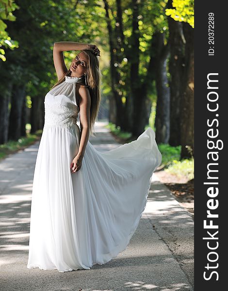 Beautiful bride woman people in fashion wedding dress posing outdoor in bright park. Beautiful bride woman people in fashion wedding dress posing outdoor in bright park