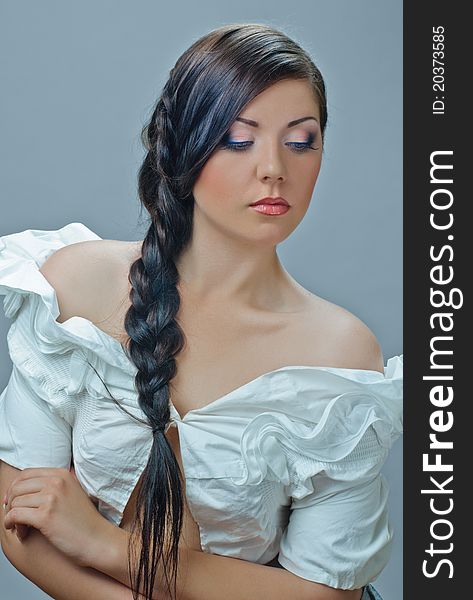 Portrait of beautiful girl with plait ongrey. Portrait of beautiful girl with plait ongrey