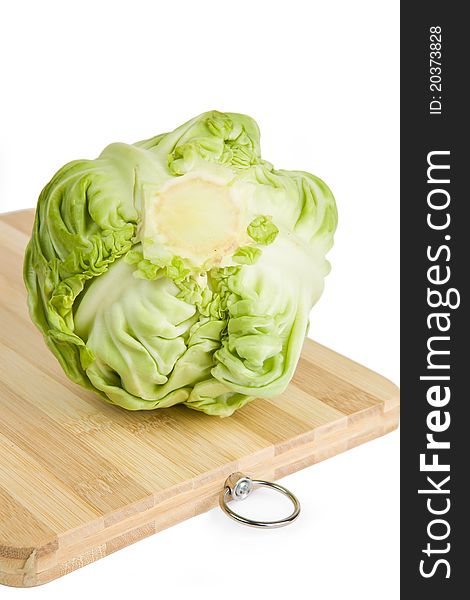 Green cabbage on wooden chopping board isolated on white background