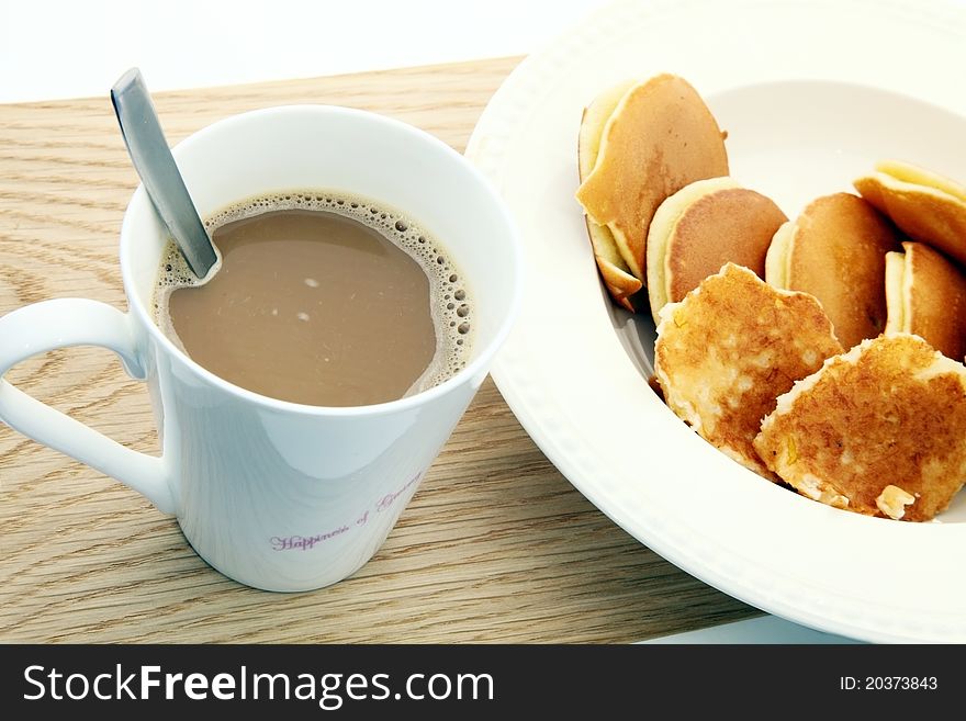 Coffee and pancake on the floor.