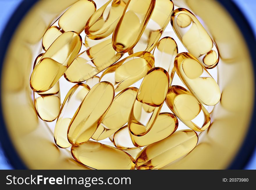 Close up of fish oil capsules inside bottle