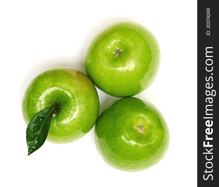 Green apples with leaves isolated on white