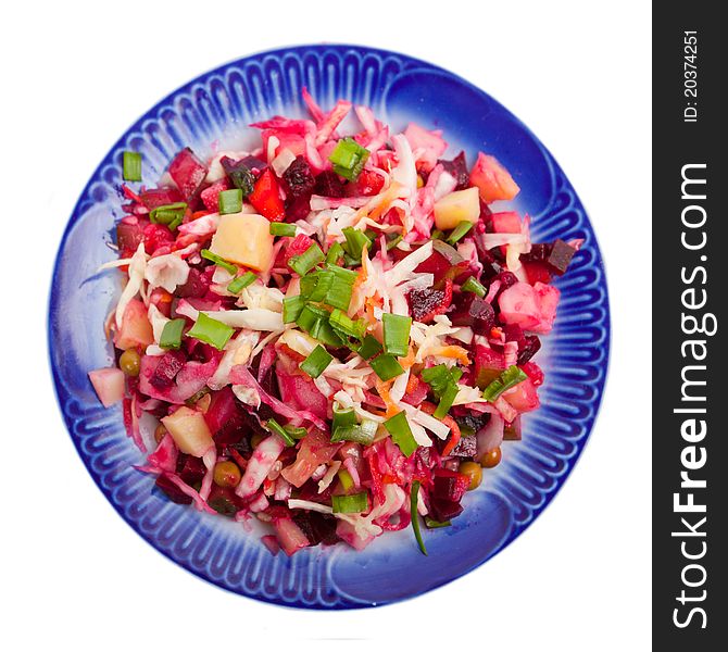 Vegetable salad on a plate with a dark blue border