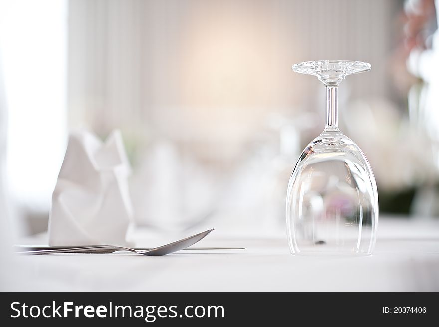 Glass goblets on white table