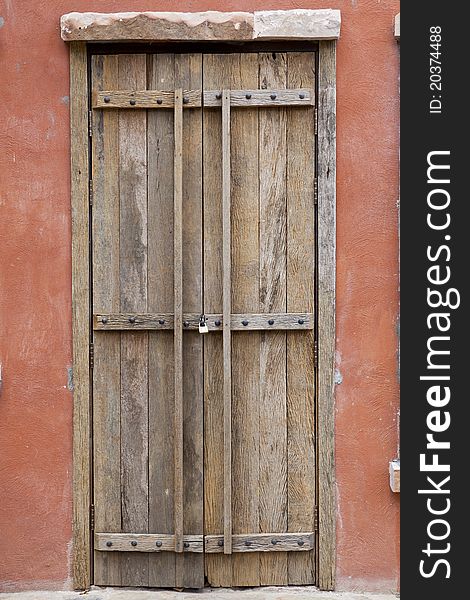 Antique wood door and orange wall