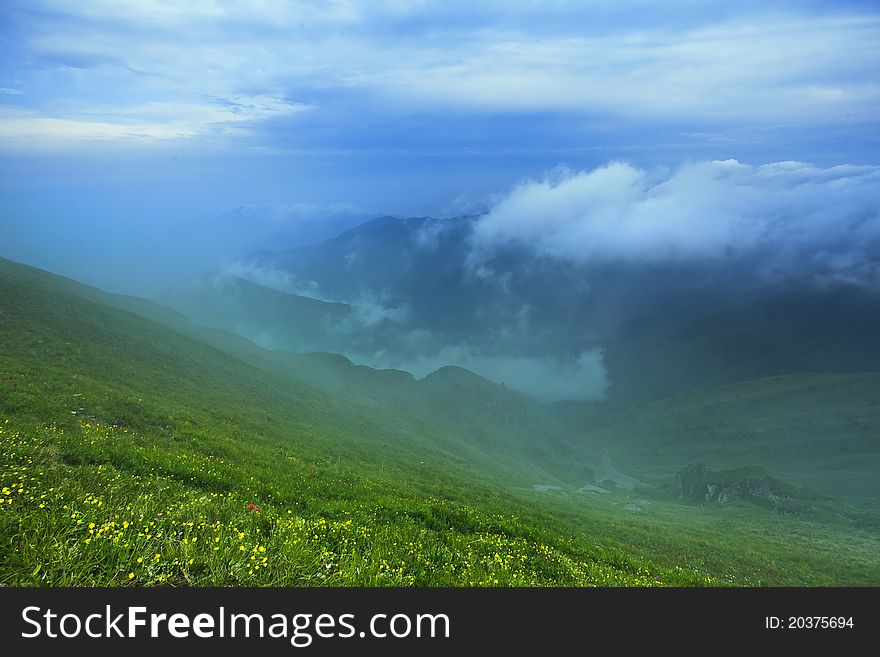 Mountain landscape with clouds and fog.