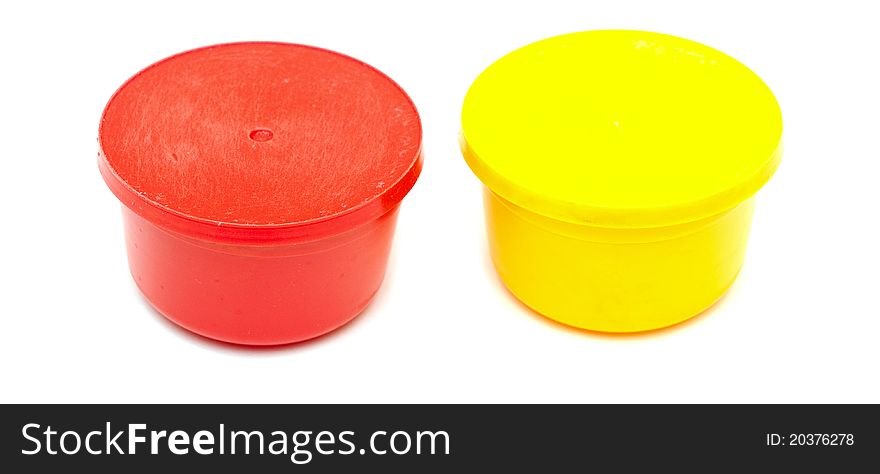 Yellow and red plastic can on white