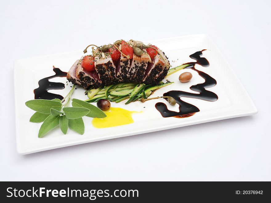 Fantasy fish with tuna and olives, tomatoes and sage